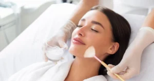 A woman receiving a chemical peel treatment on her face in Boynton Beach, FL